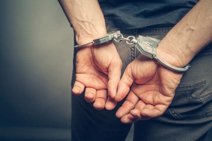 Male,Hands,In,Handcuffs