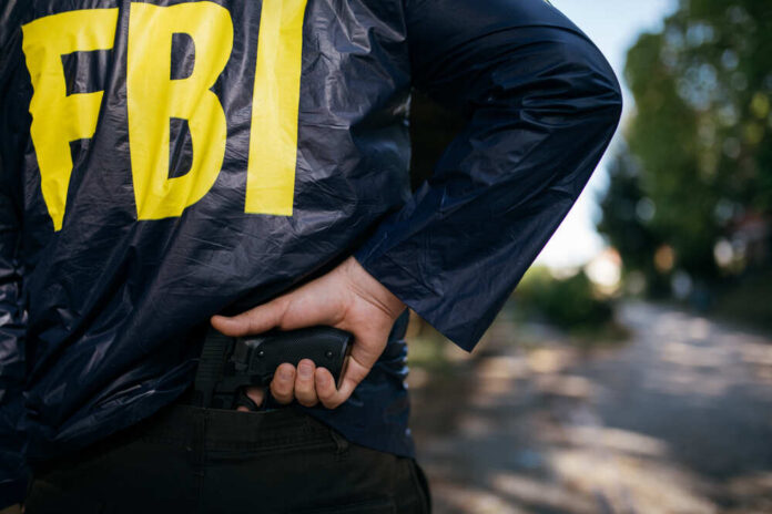 Cropped,Photo,Of,Fbi,Agent,In,Action,With,A,Pistol,