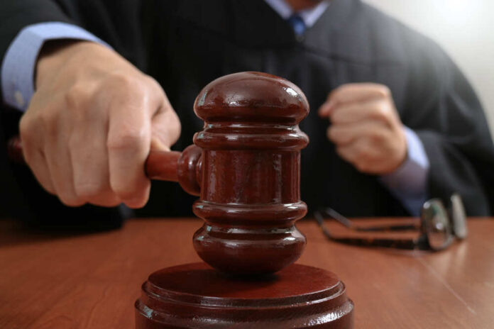 Justice,And,Law,Concept.male,Judge,In,A,Courtroom,Striking,The