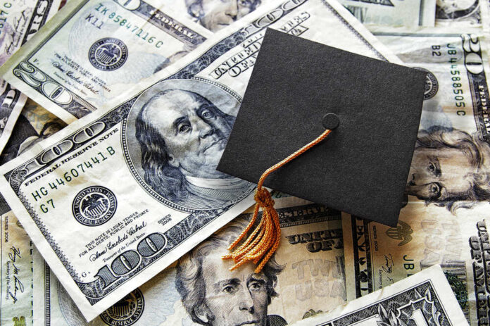 Miniature,Graduation,Cap,On,Hundred,Dollar,Bills