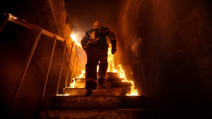 Strong,And,Brave,Firefighter,Going,Up,The,Stairs,In,Burning
