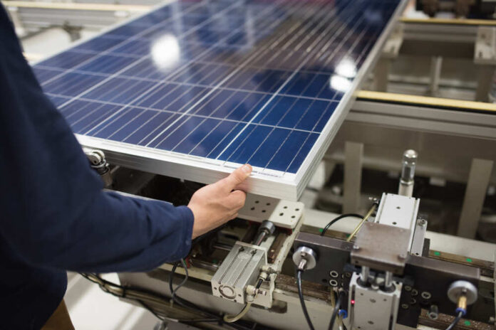 Production,Of,Solar,Panels,,Man,Working,In,Factory.
