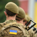 Ukraine’s Exoskeletons: Military’s NEW Power Play Soldiers in uniform with Ukrainian flag patches.