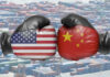 Boxing gloves with US and China flags clash