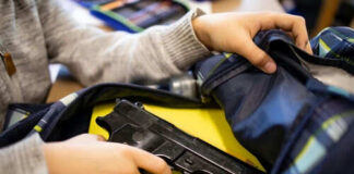 Person places handgun into a backpack