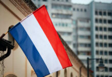 Netherlands flag waving outside buildings