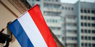 Netherlands flag waving outside buildings