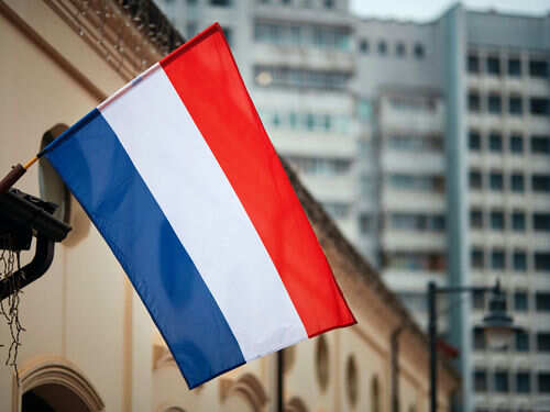 Netherlands flag waving outside buildings