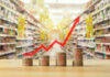 Rising graph over stacked coins in grocery store