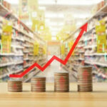 Rising graph over stacked coins in grocery store