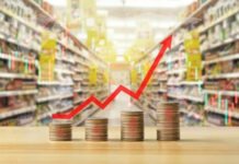 Rising graph over stacked coins in grocery store