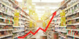 Rising graph over stacked coins in grocery store