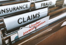 File folders labeled insurance, fraud, claims, investigation.