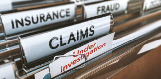 File folders labeled insurance, fraud, claims, investigation.