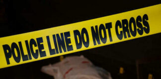 Police tape and covered figure at crime scene