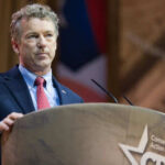 Person speaking at a podium during a conference