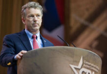 Person speaking at a podium during a conference