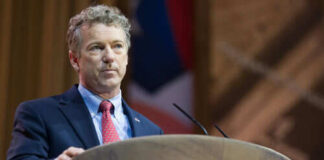 Person speaking at a podium during a conference