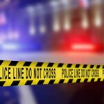 ICE Detainer Issued for Loyola Murder Suspect Yellow police caution tape with the text 'POLICE LINE DO NOT CROSS' in a blurred background