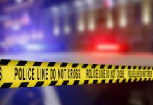 ICE Detainer Issued for Loyola Murder Suspect Yellow police caution tape with the text 'POLICE LINE DO NOT CROSS' in a blurred background