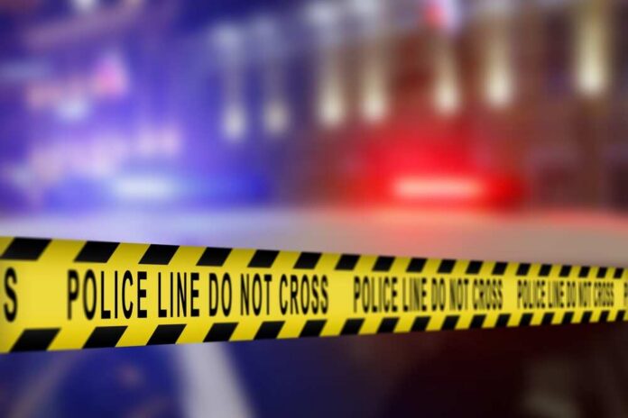 Yellow police caution tape with the text 'POLICE LINE DO NOT CROSS' in a blurred background