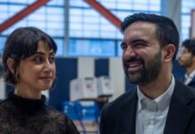 Scandalous Posts Erupt — NYC Mayor Scrambles Two individuals engaged in conversation at a polling station