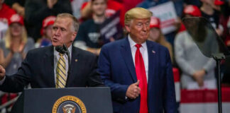 Two men speaking at a political rally event