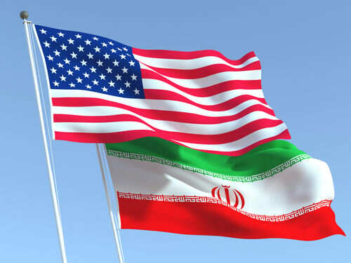 American and Iranian flags waving in the sky.