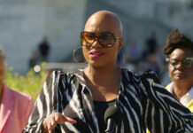 Person speaking outdoors wearing zebra print jacket