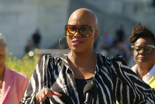 Person speaking outdoors wearing zebra print jacket