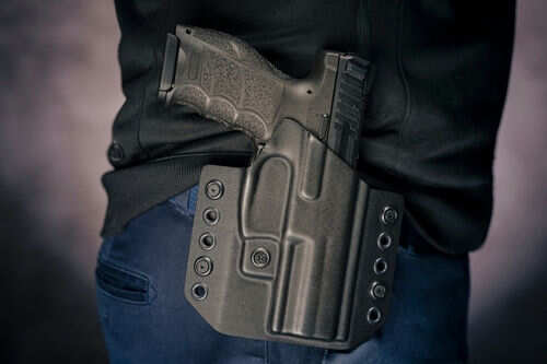 Person wearing gun in a holster on hip
