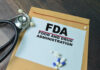 FDA paper with medical items on wooden table.