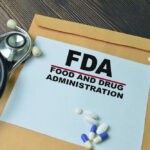 FDA paper with medical items on wooden table.