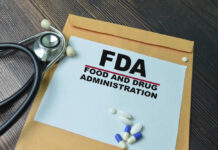 FDA paper with medical items on wooden table.