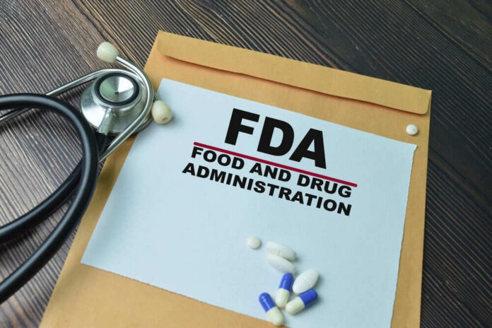 FDA paper with medical items on wooden table.