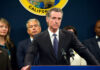 Person speaks at podium with California seal behind.