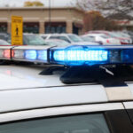 Close-up of a police car's emergency lights in a parking lot