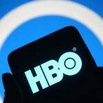 HBO logo displayed on a smartphone against a blue background