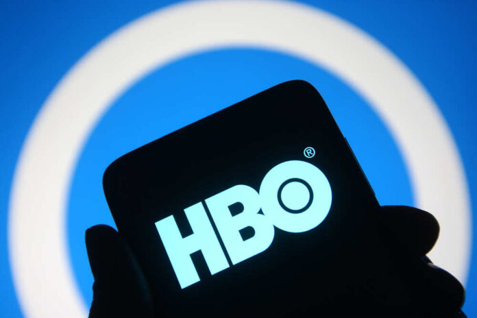 HBO logo displayed on a smartphone against a blue background