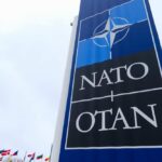 Trump Threatens NATO Over Iran Chaos NATO sign with flags in the background
