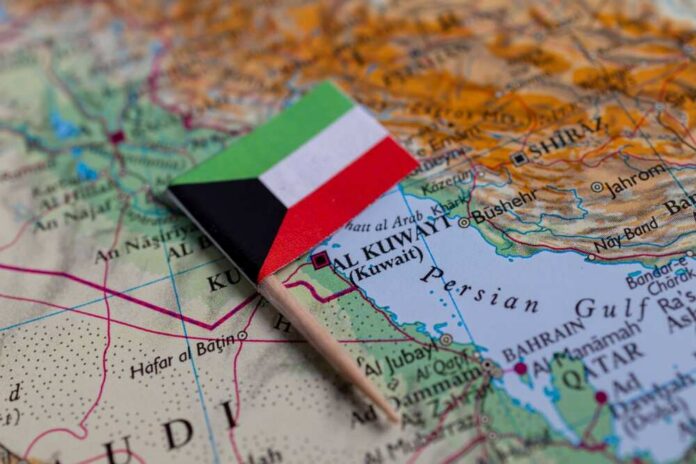 Small flag of Kuwait placed on a map of the Middle East