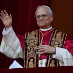Pope Vs. Trump: Vatican Clash Religious leader in ceremonial attire waving from a balcony