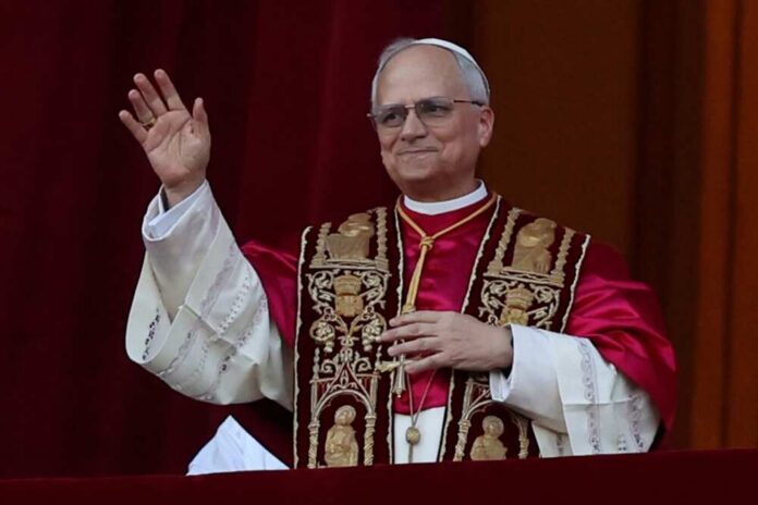 Religious leader in ceremonial attire waving from a balcony