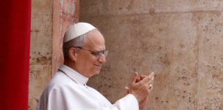 Pope clapping and smiling during a public appearance