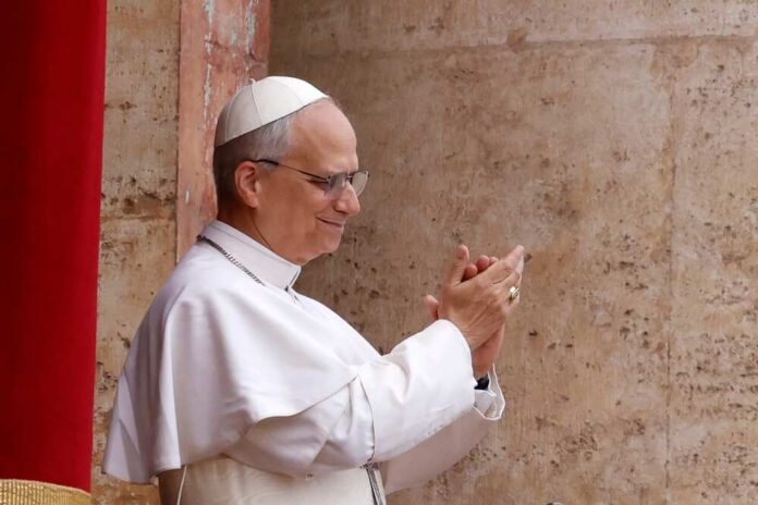 Pope clapping and smiling during a public appearance