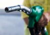 U.S. Gas Prices Soar Amid Hormuz Turmoil Close-up of a hand holding a green fuel pump nozzle