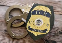 ICE Operation Fiasco: Child Left Alone in Car ICE officer badge next to handcuffs on a wooden surface