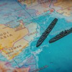 A close-up of a map featuring military ships in the Arabian Sea