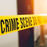 Yellow crime scene tape with the words 'CRIME SCENE DO NOT CROSS'