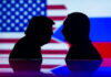 Two silhouettes facing each other with flags background